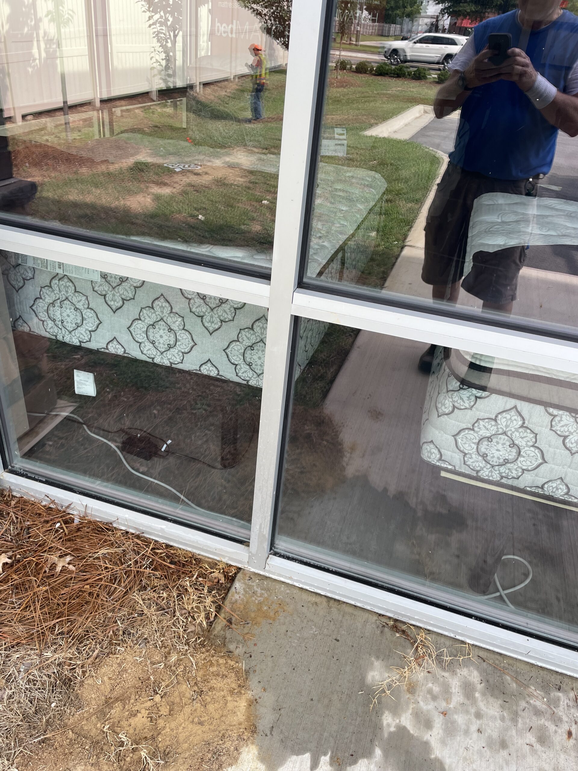 Clean commercial glass reflecting the surrounding property